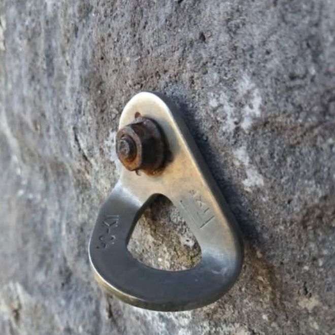 An old hanger on the rock with a rusted nut